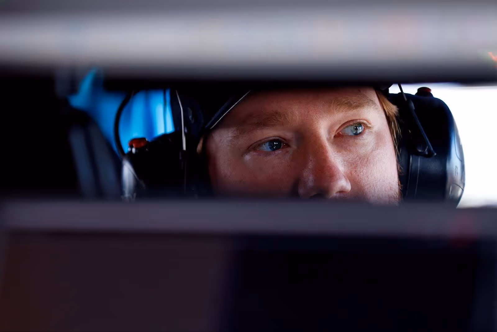 Shot of Tyler Reddick through a rear view mirror