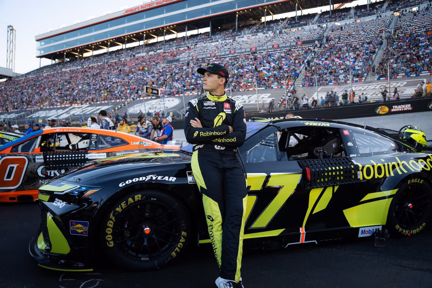 Corey Heim standing next to 67 car.