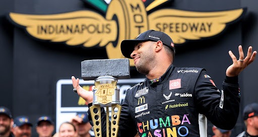 Bubba Wallace posing cheekily with his trophy