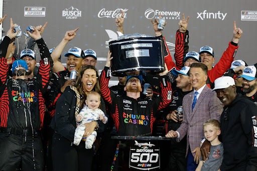 Tyler Reddick and crew holding up trophy after Daytona 500 victory