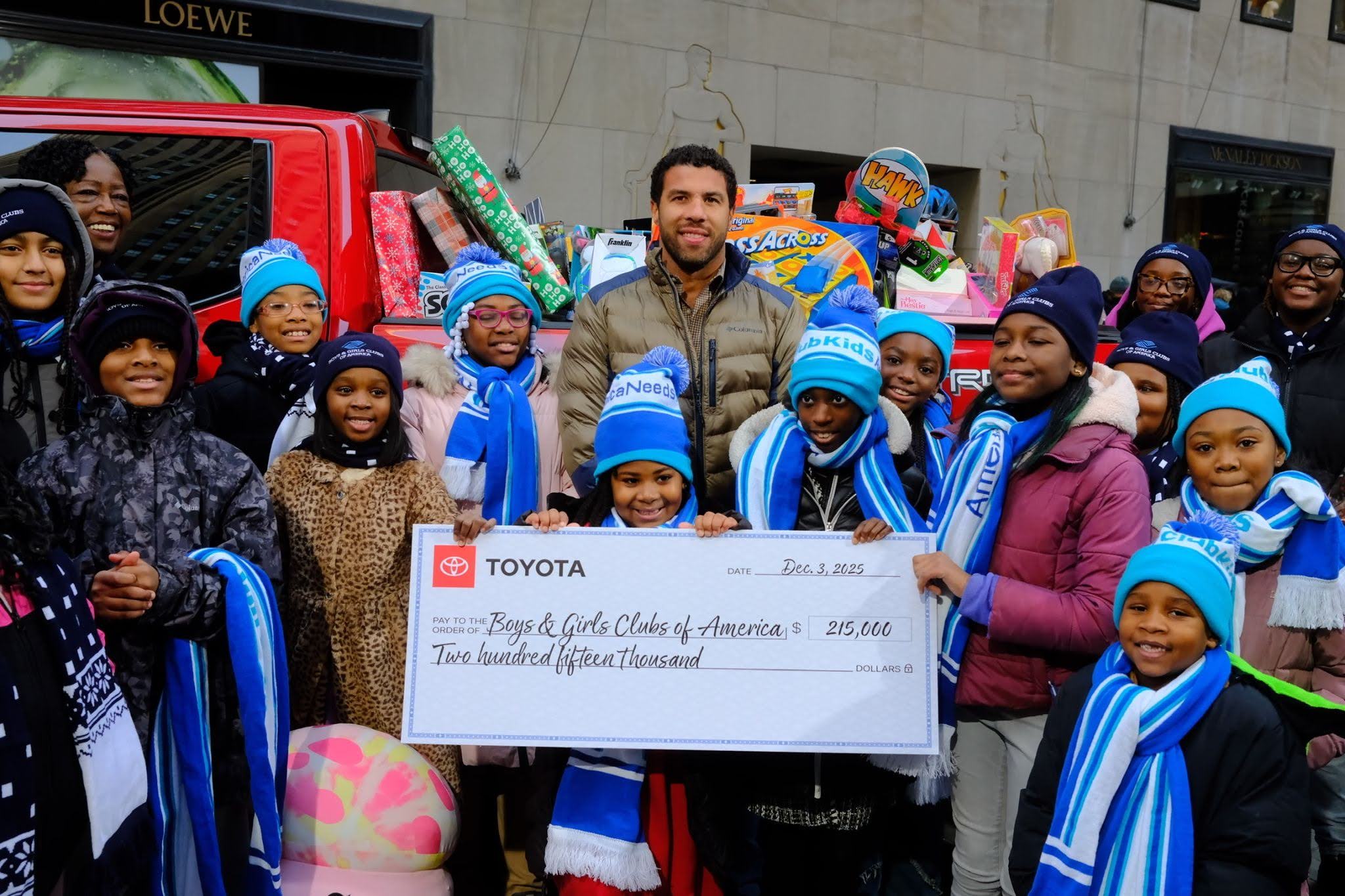 Bubba Wallace with the Boys and Girls Clubs of America holding a large check