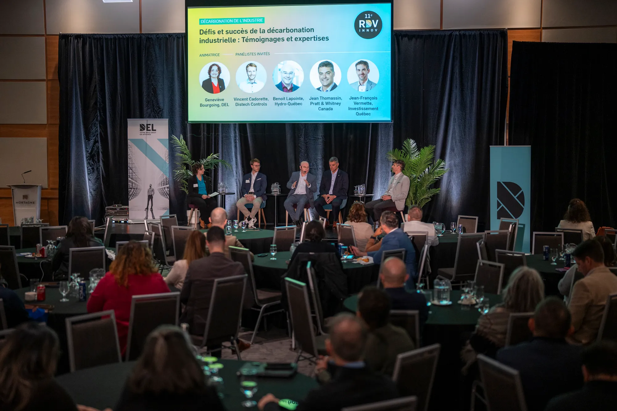 A panel discussion on stage at a conference RDV Innov event