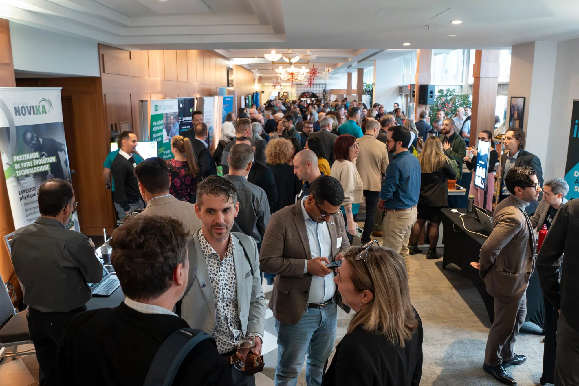 Attendees networking and interacting at a busy exhibition area at RDV Innov