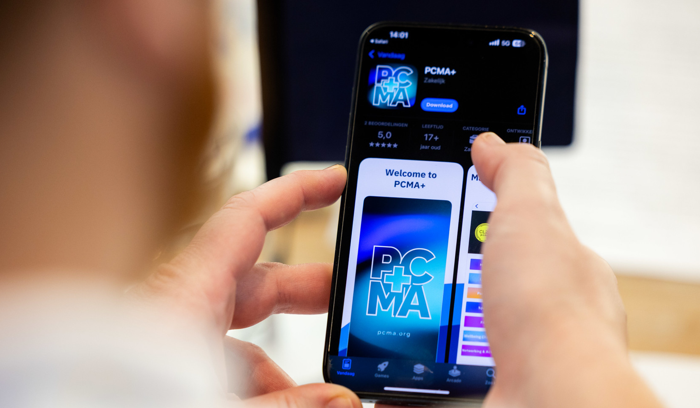 Attendee using the PCMA+ event app on a smartphone during PCMA Convening EMEA 2025 in Rotterdam, powered by Swapcard.