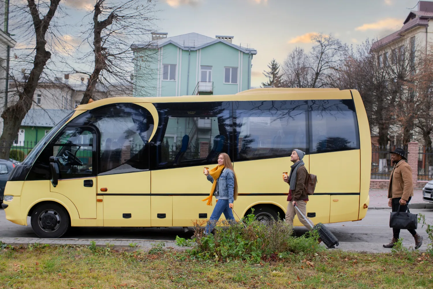 A yellow bus parked on the side of the road.