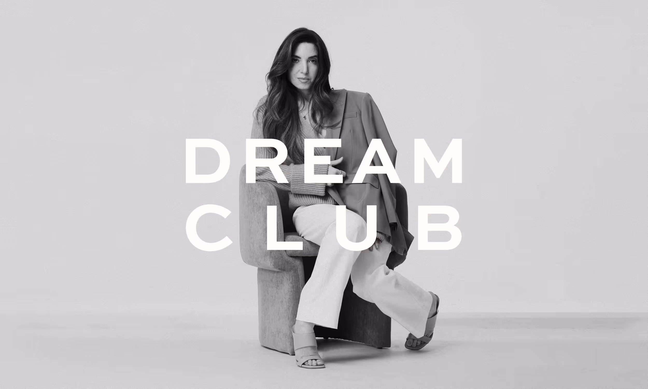 A high-fashion, black and white photo of Marie Forleo, with the words DREAM CLUB elegantly layered on top.