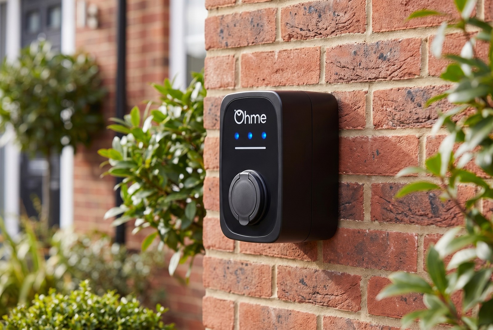 Ohme ePod home EV charger mounted on a brick wall