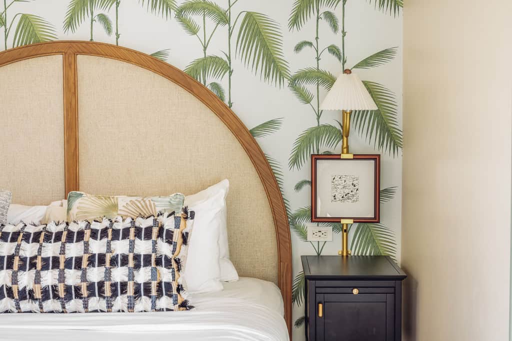 Pillows on a large bed, small black furniture to the right