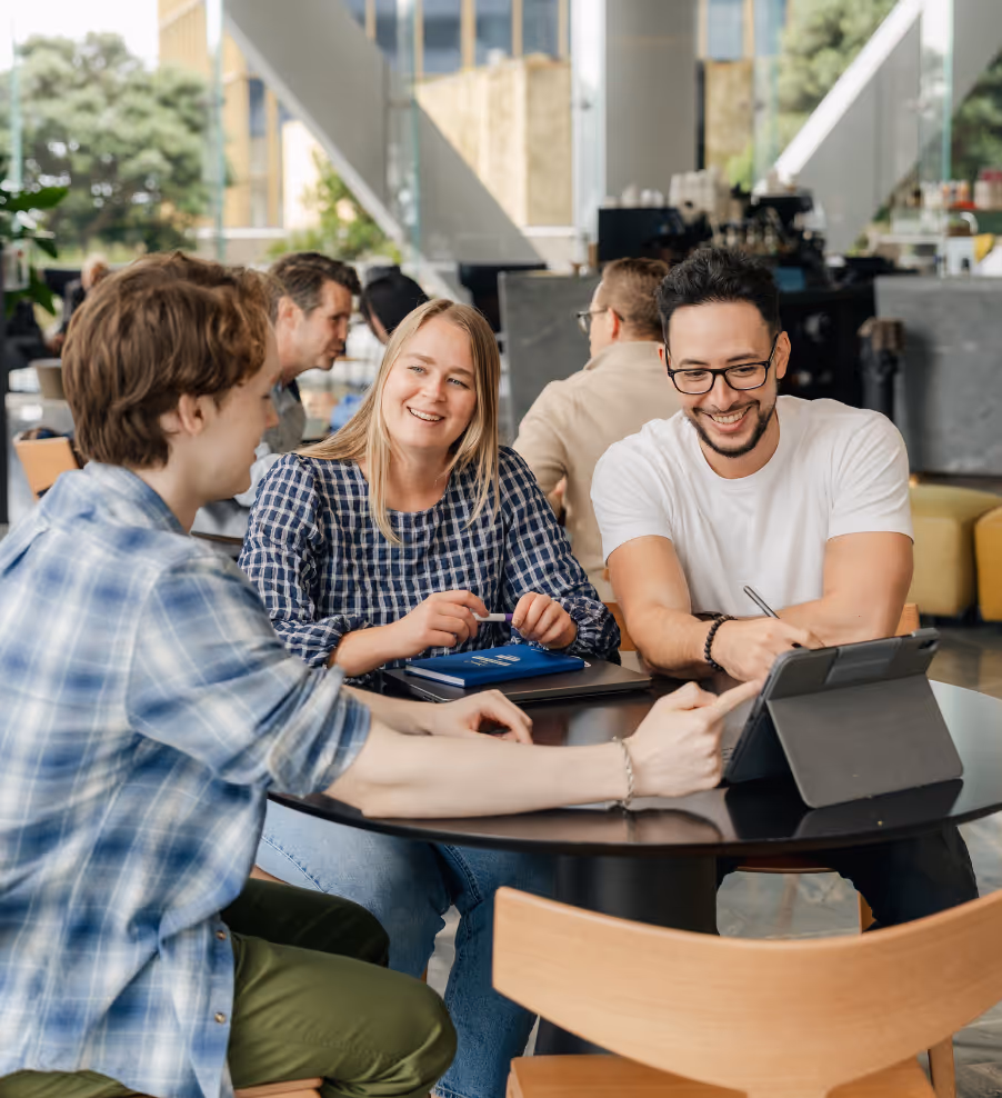 Three members of the UneeQ team discussing a digital human project.