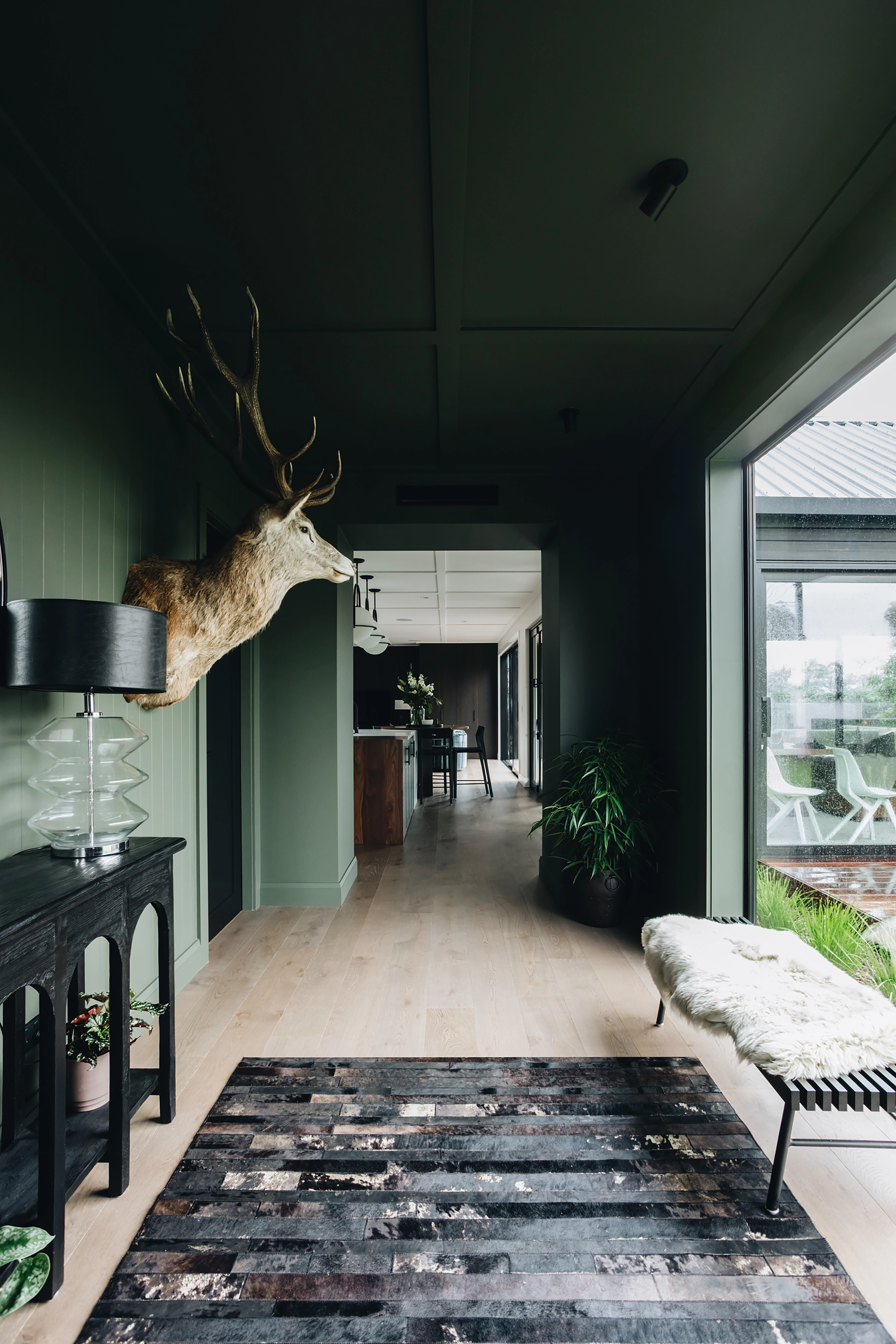 Warm wooden flooring in moody foyer entrance