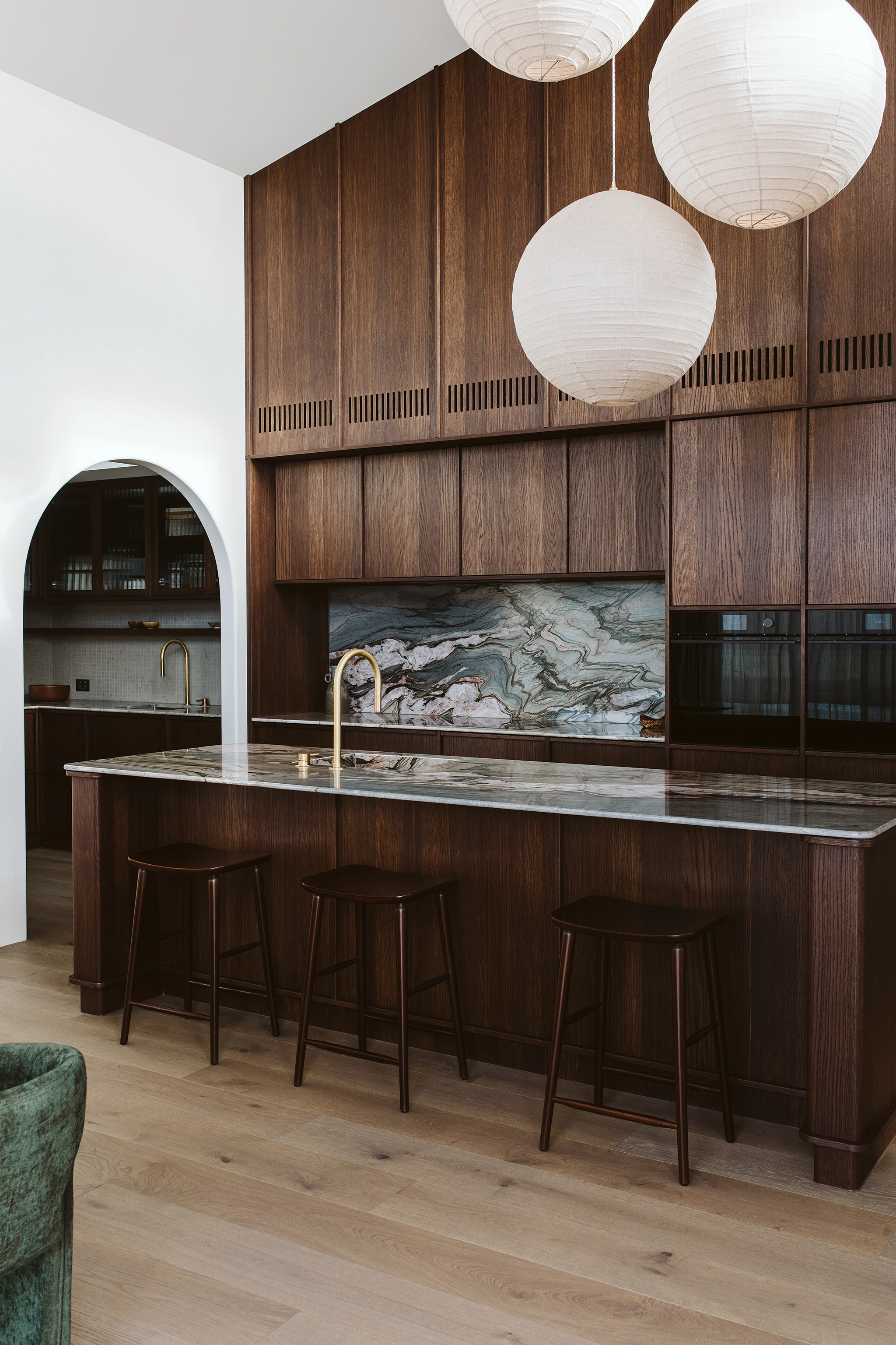 Rich dark oak veneer cupboards in kitchen