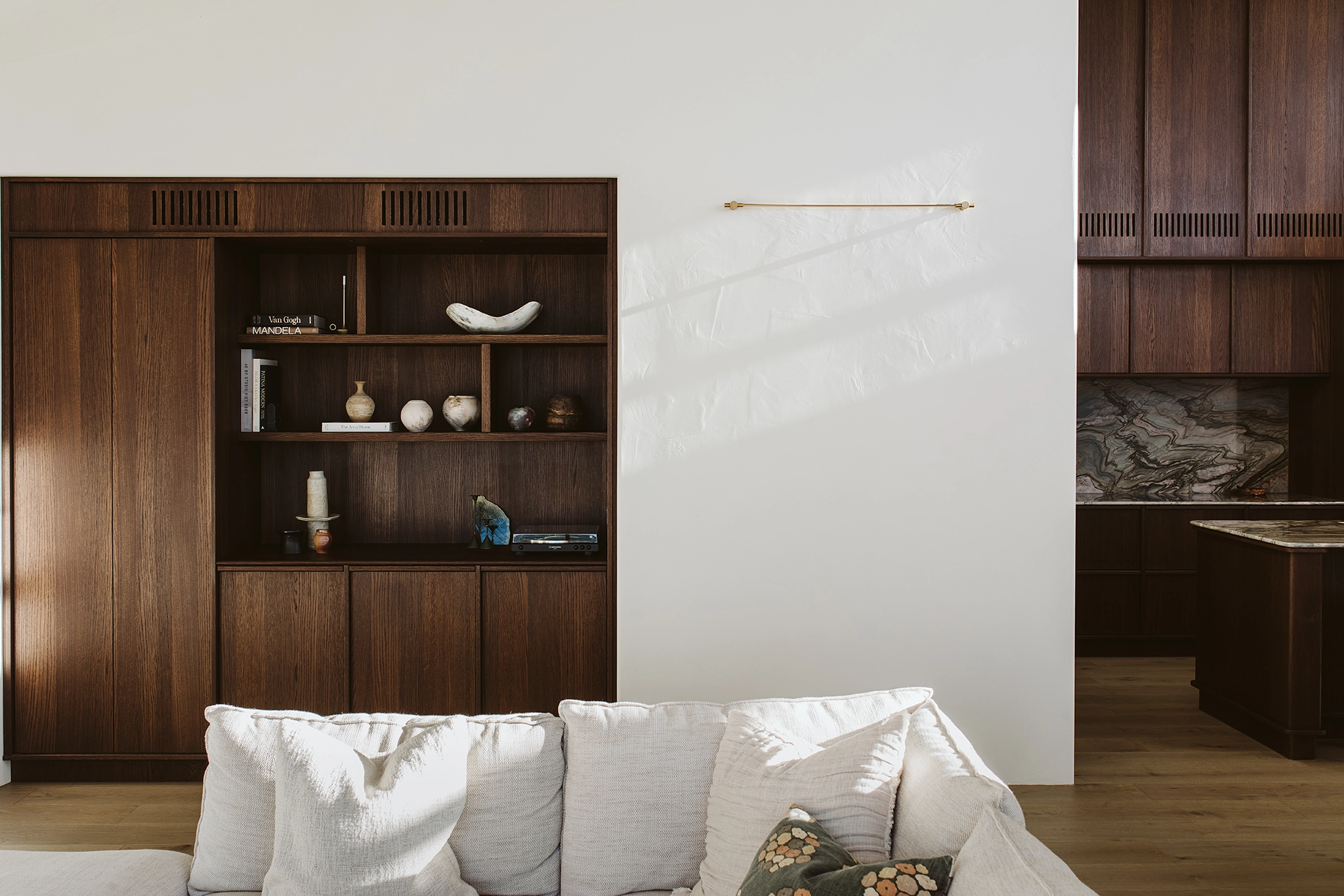 Rich dark oak veneer panels with built-in storage