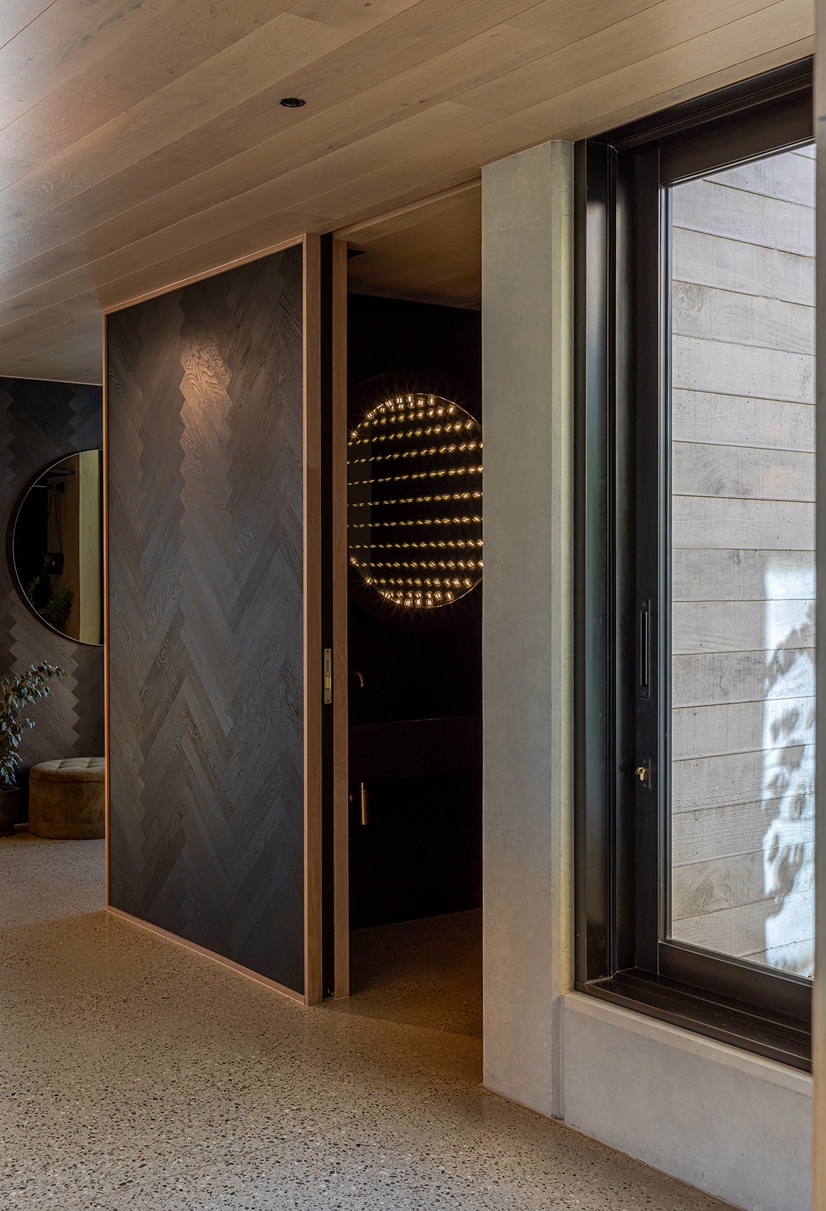 Dark herringbone oak timber wall detail in living space