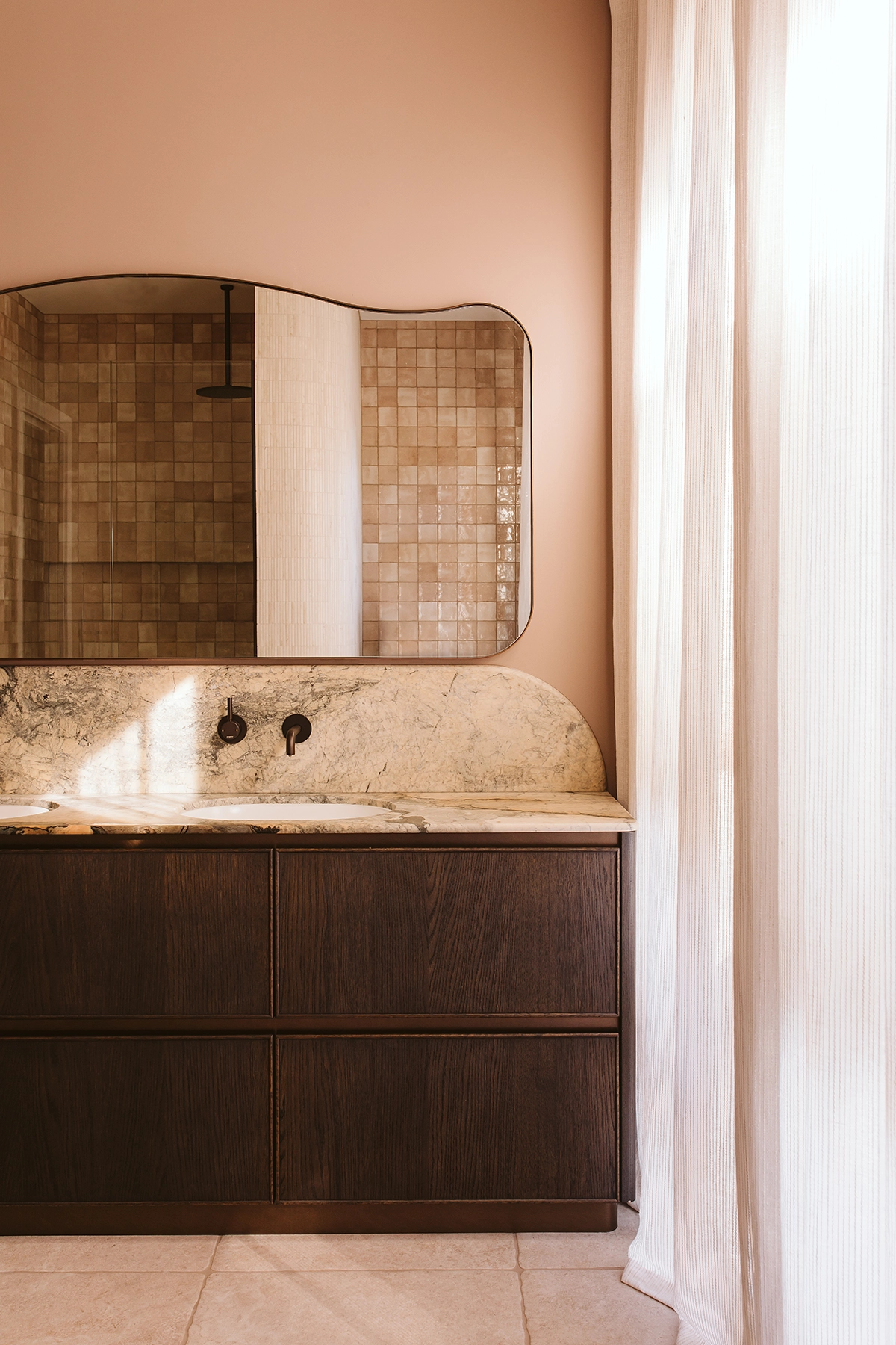 Layered material palette featuring timber and marble in bathroom