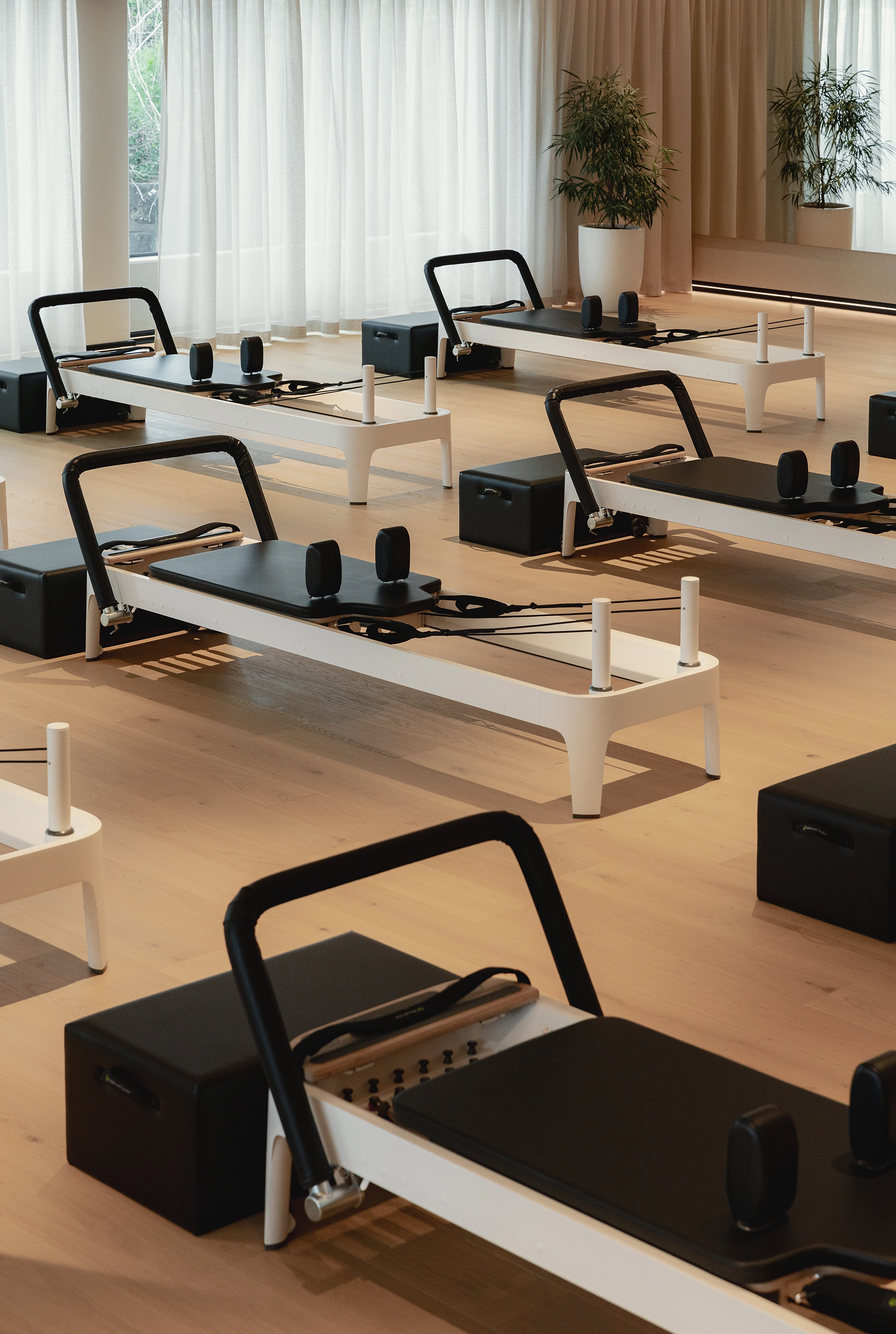 Les Mills Pilates studio with natural wood floors