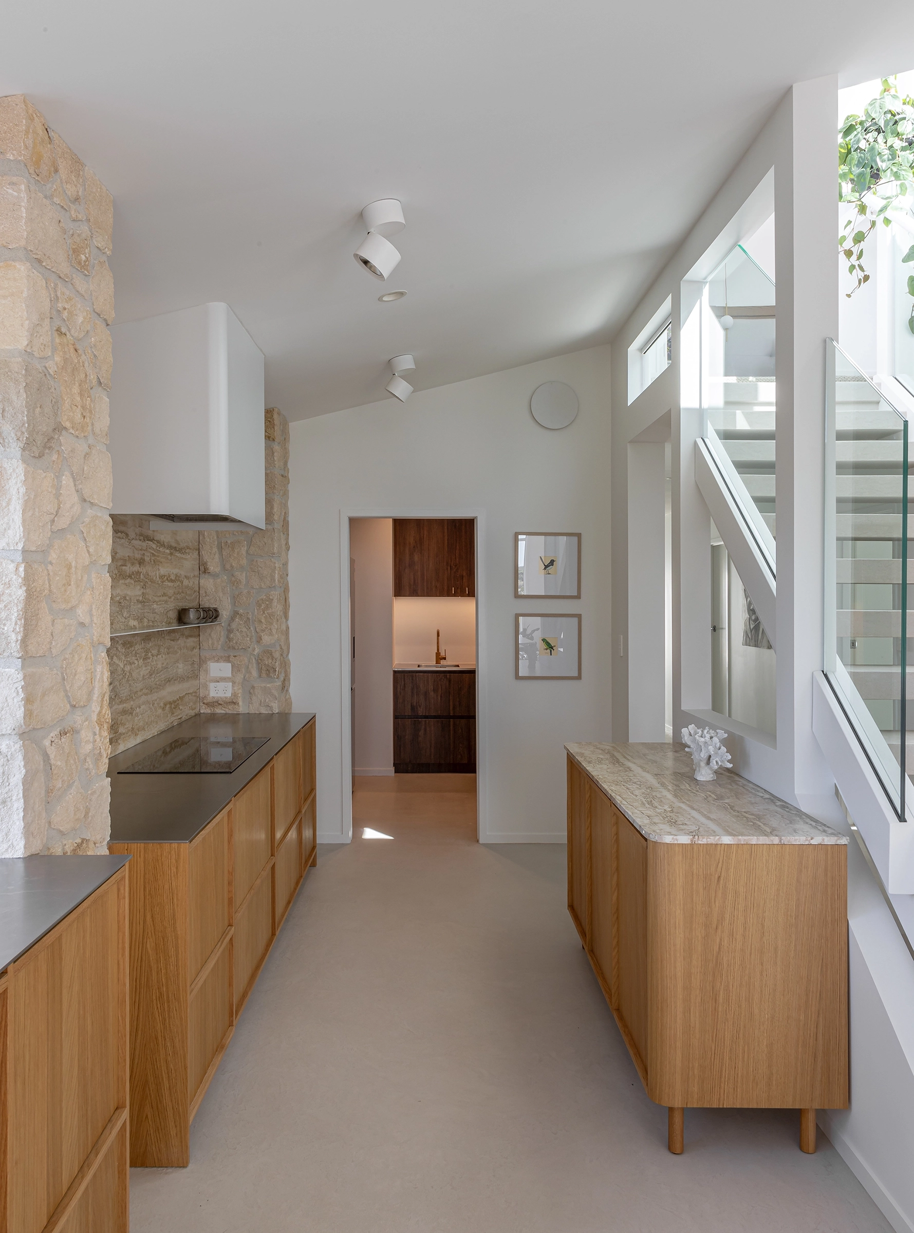 Light-filled coastal kitchen with stone pillars and hidden storage
