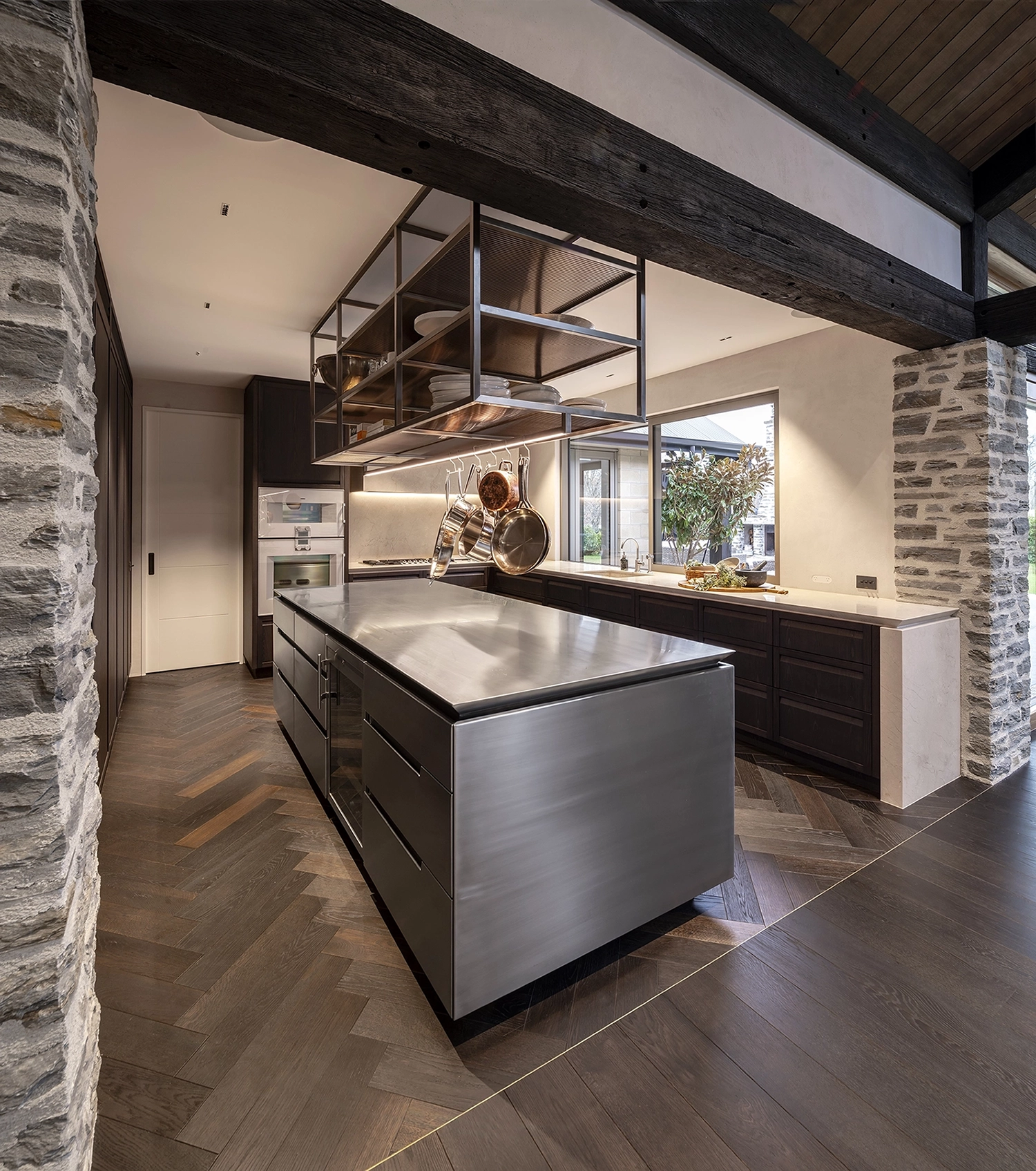 Kitchen island anchoring the space with rich oak timber flooring