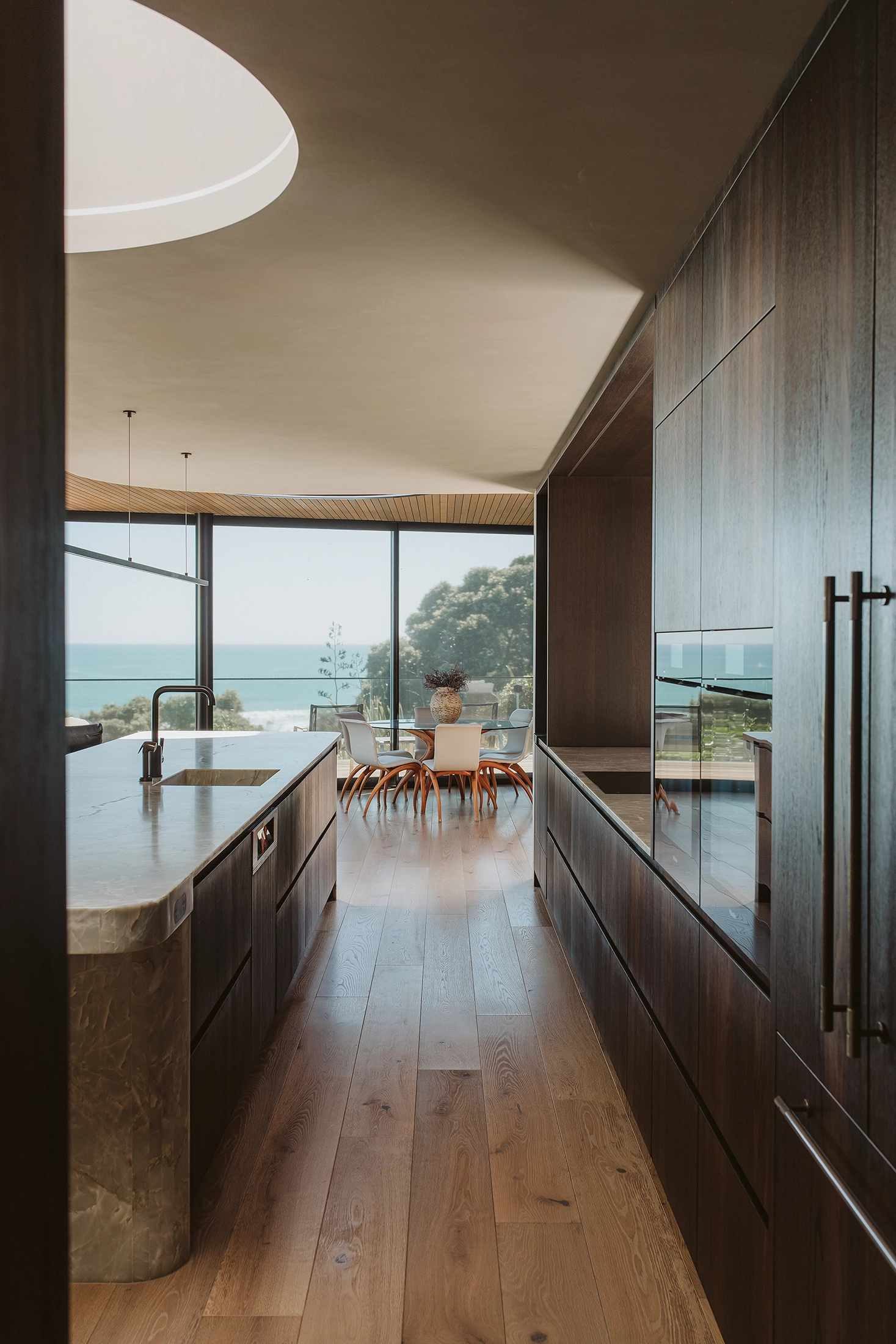 Smoked oak timber cabinetry with bronze accents