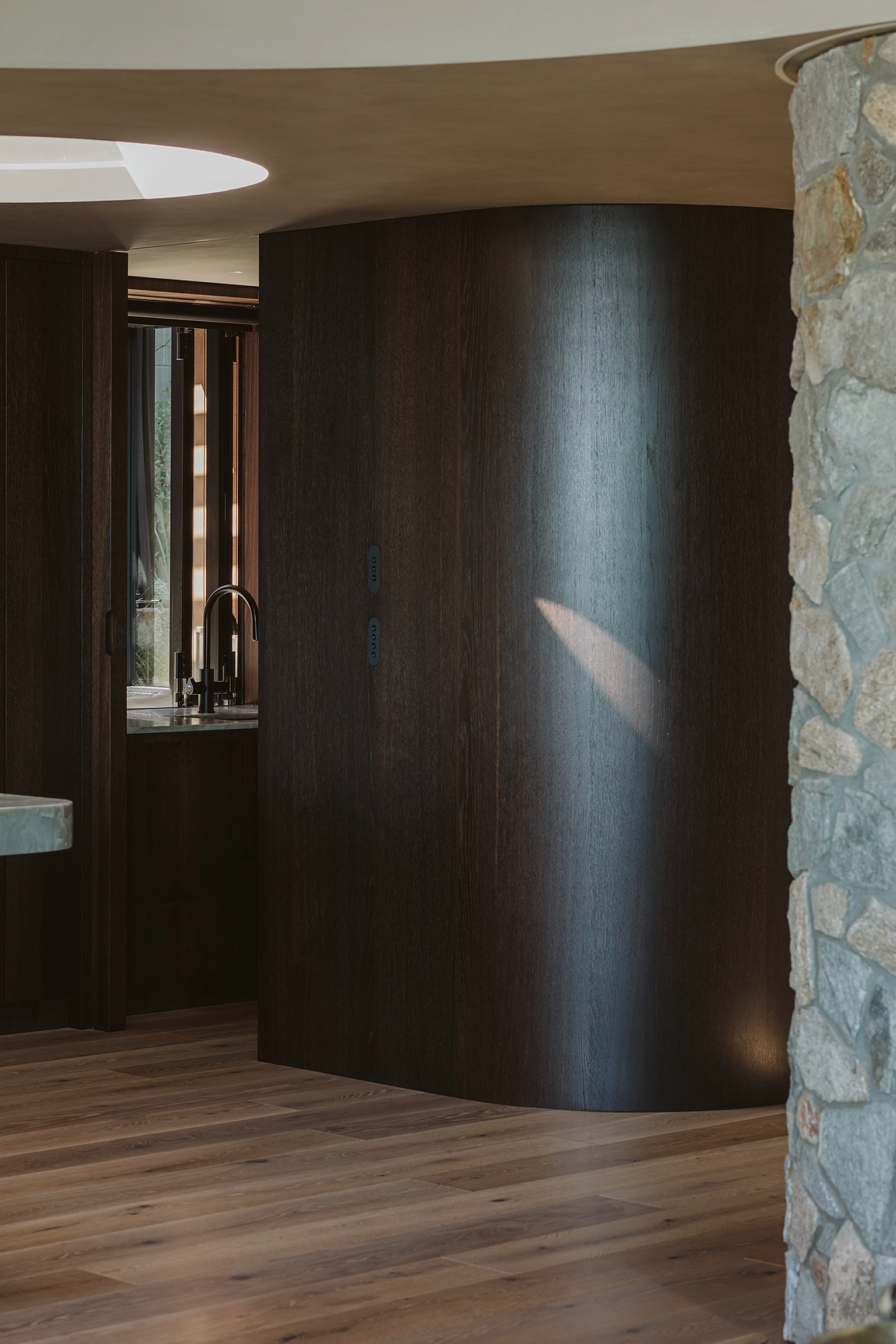 kitchen featuring smoked oak timber veneer around curves
