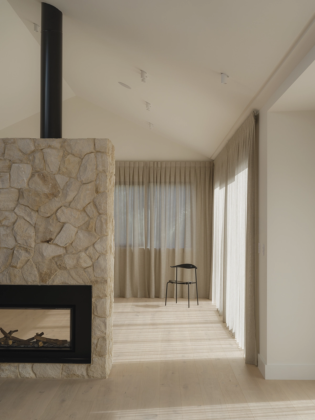 Pale TRUNK Elza timber flooring NZ running continuously through an open-plan Auckland interior, Z Architecture