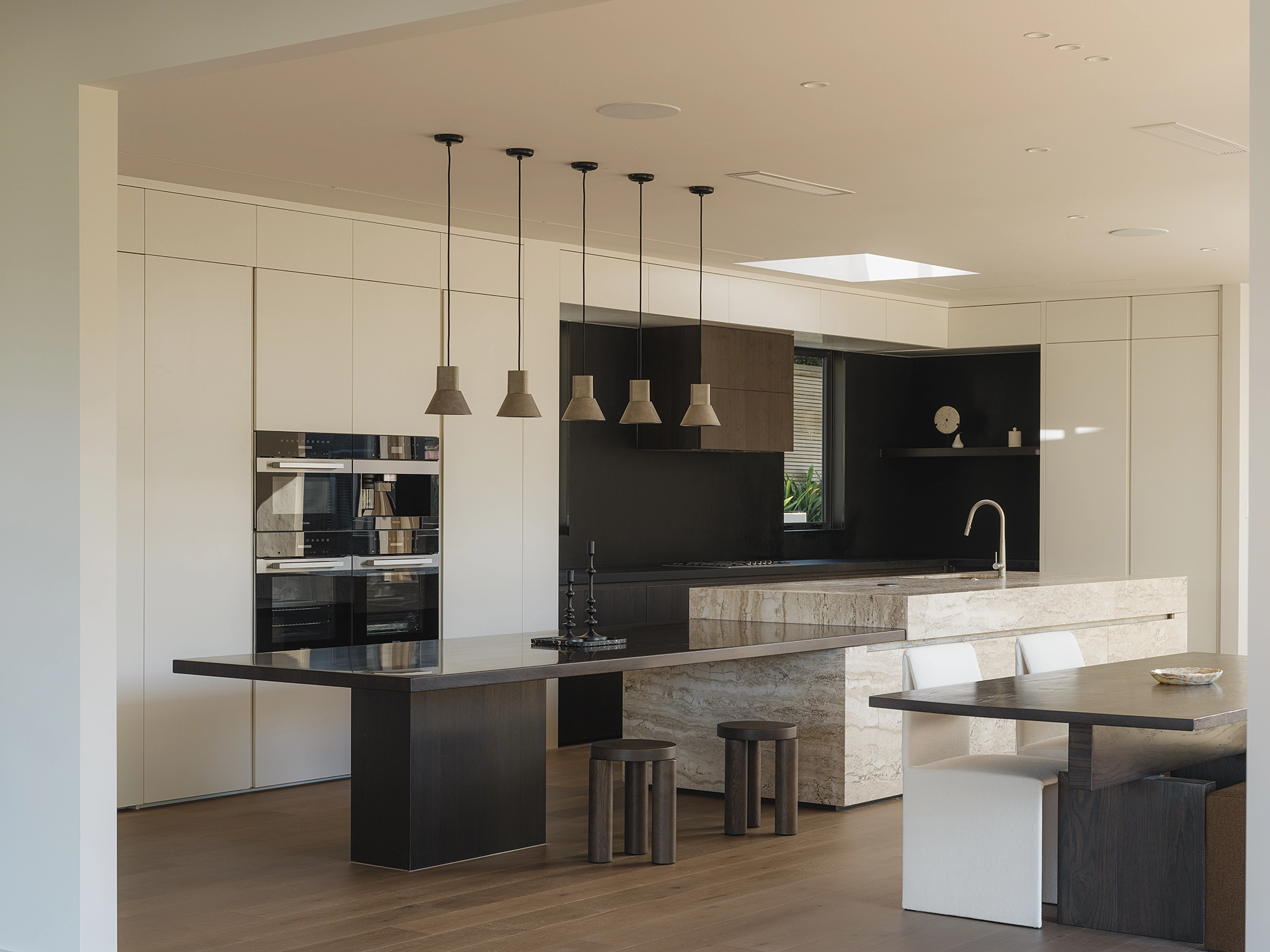 Smoked timber flooring NZ flowing continuously from entry through kitchen and dining, Codrington Residence Auckland