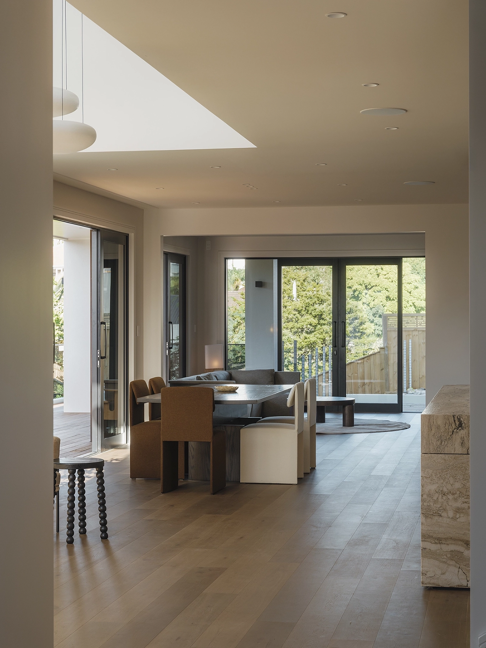 Natural light shifting across TRUNK Vetra smoked timber flooring NZ through skylights, Codrington Residence