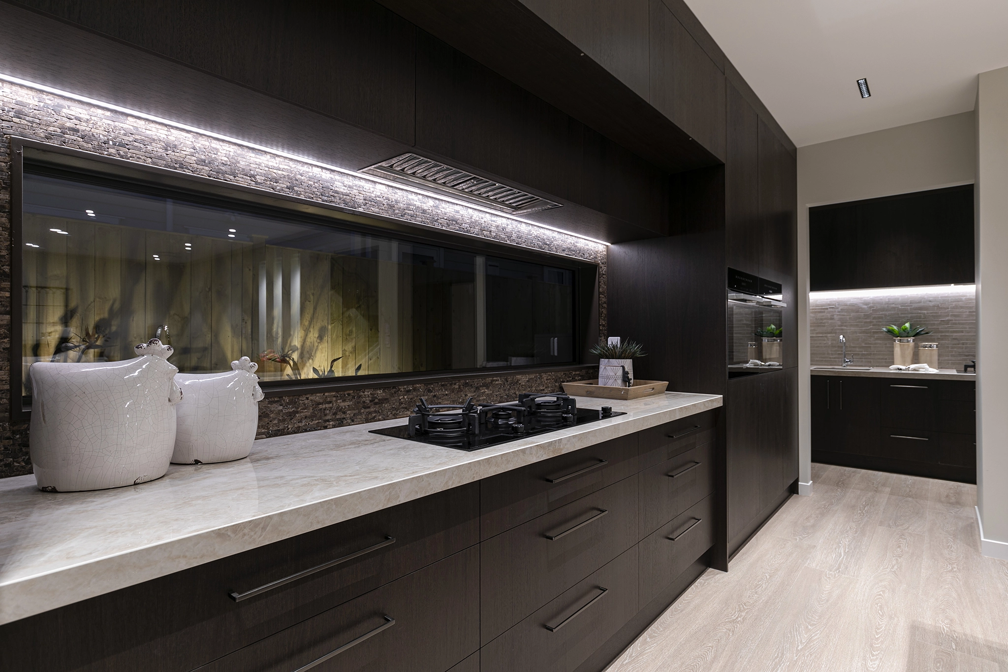 Pepeke Way Auckland kitchen with Stardust Walnut dark timber joinery in a Master Builders award-winning home