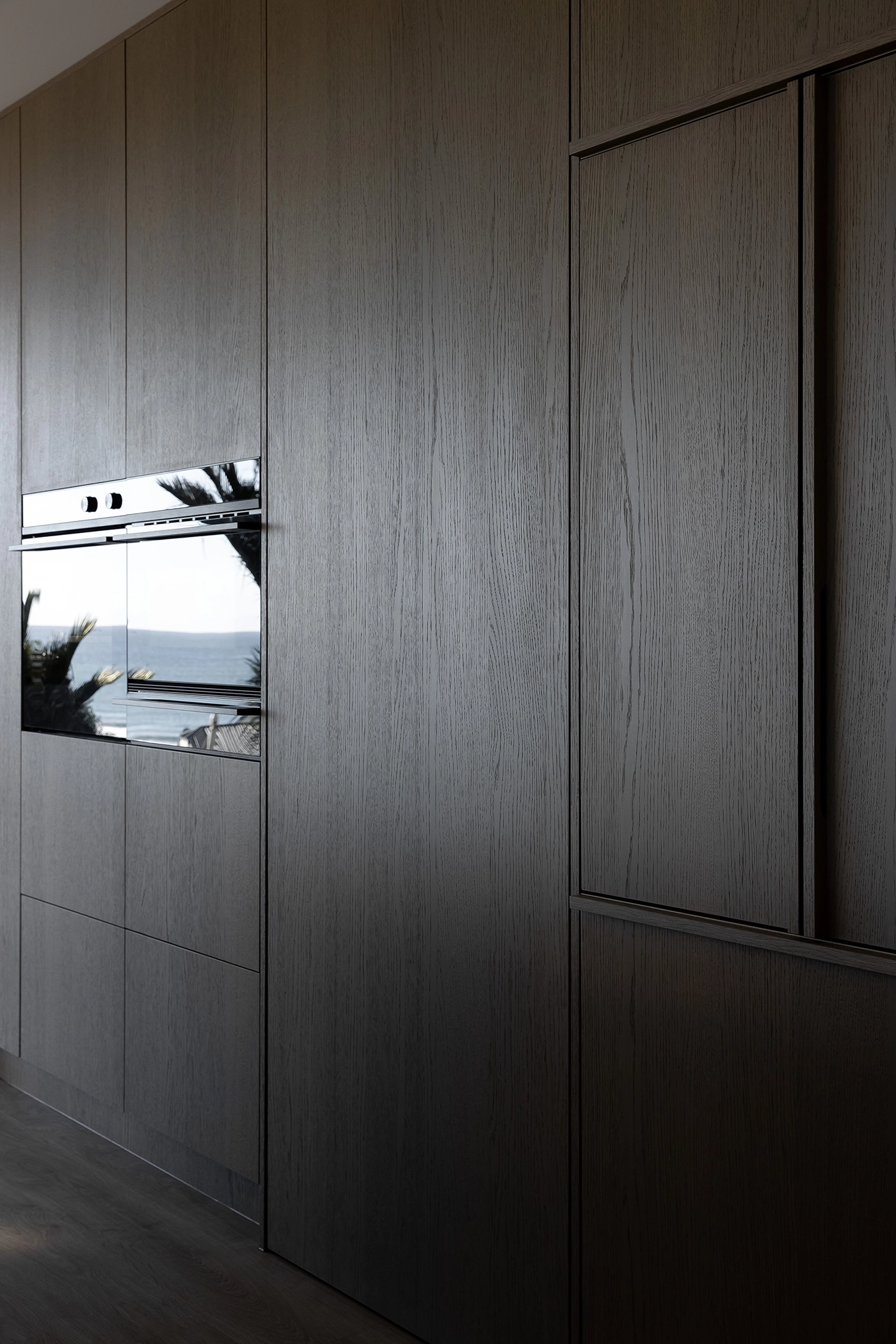 Floor-to-ceiling prefinished timber veneer NZ island in a contemporary Oakura, Taranaki kitchen