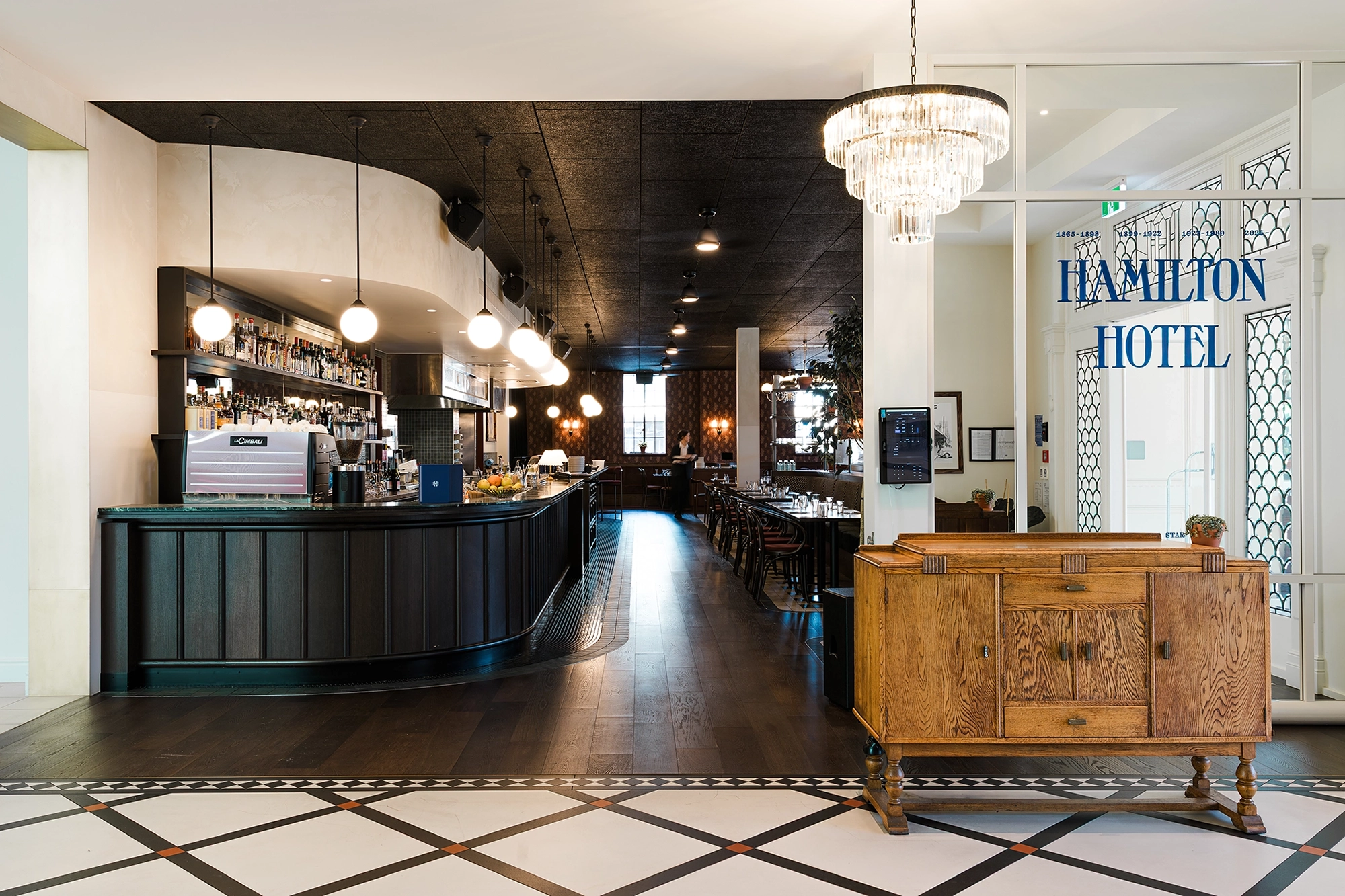 Smoked timber flooring NZ as a foundational finish connecting the long narrow floor plan, Hamilton Hotel