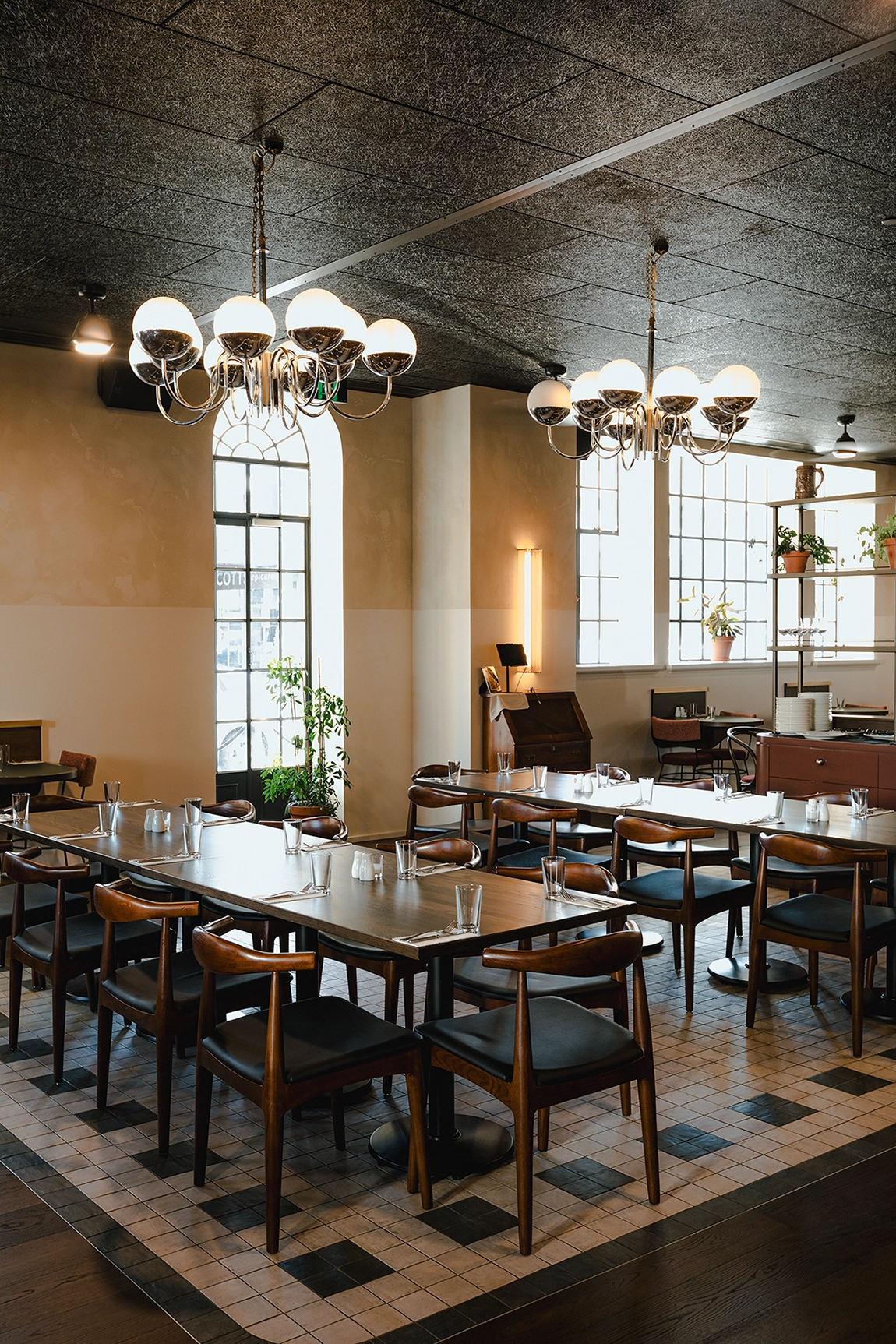 Smoked timber flooring NZ beneath bespoke furniture settings in a relaxed high-energy bar, Hamilton Hotel
