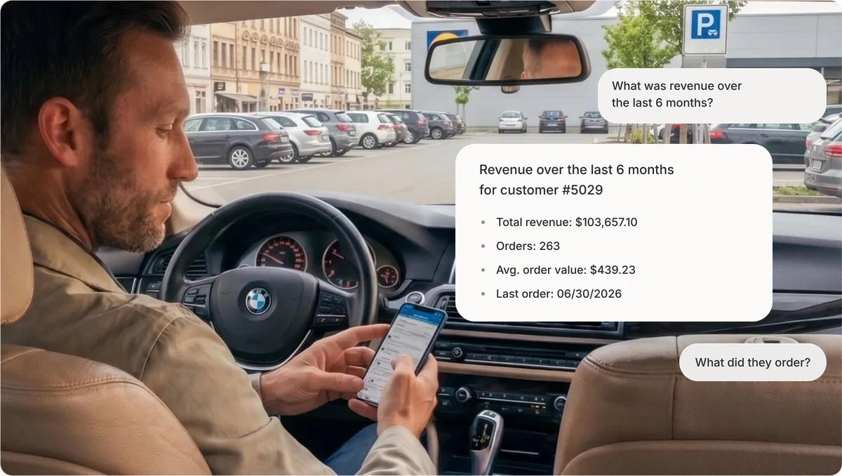 Field rep in his car in a parking lot, asking Acto about a customer's revenue on his phone