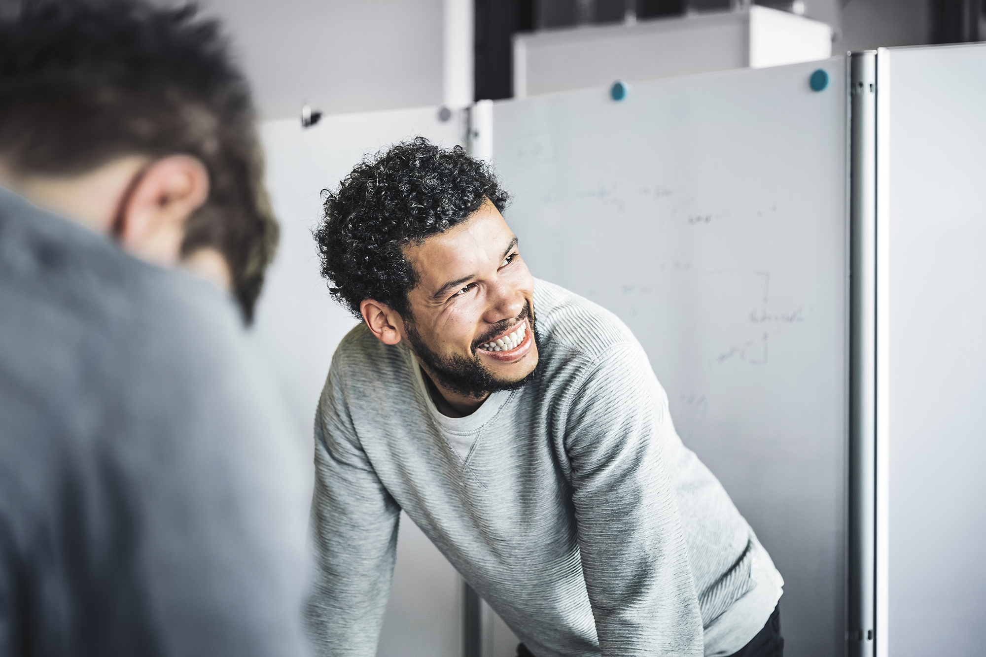 Man smiling while looking in a mirror