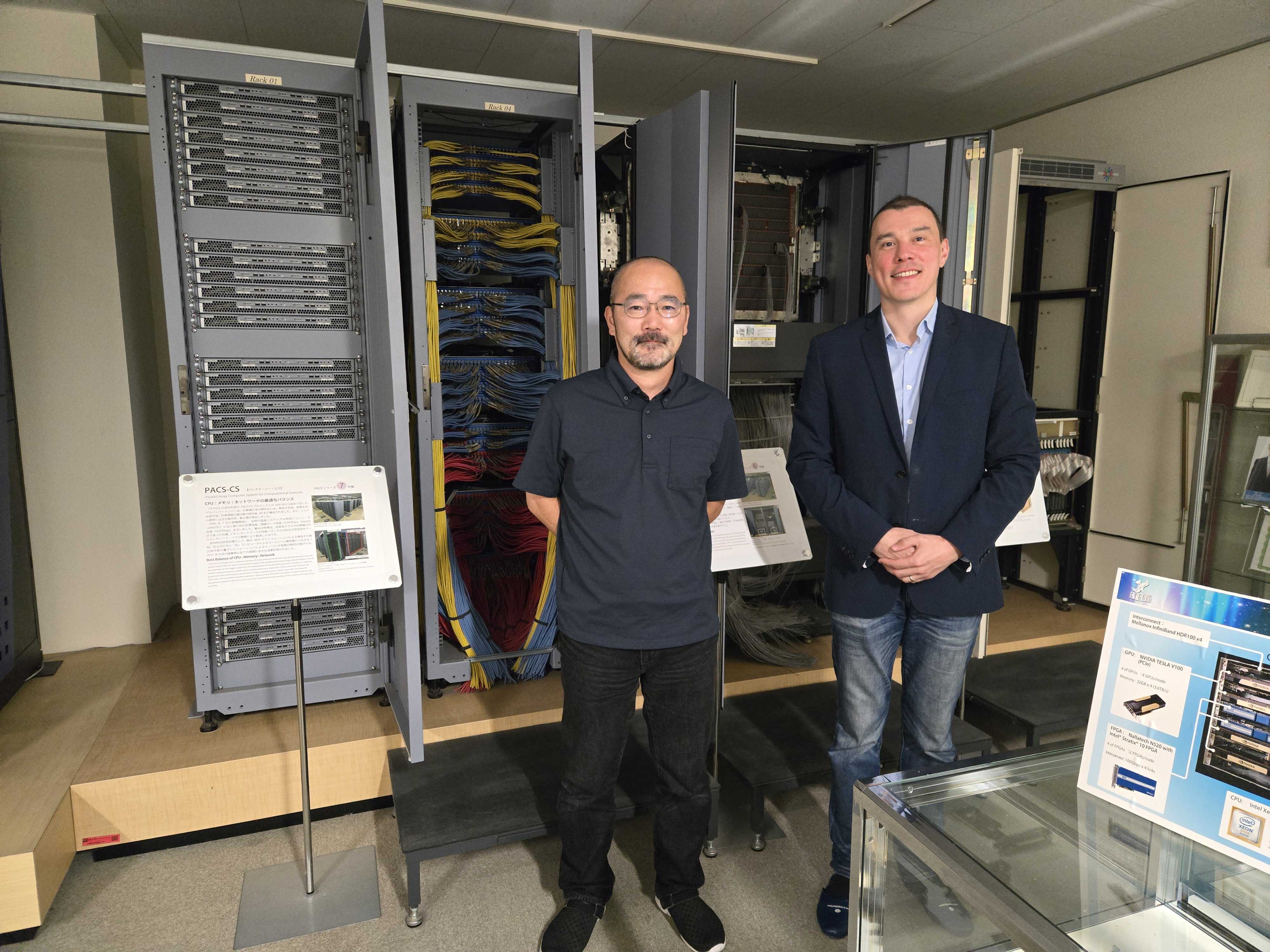 Standing in front of the PACS-CS supercomputer rack at CCS