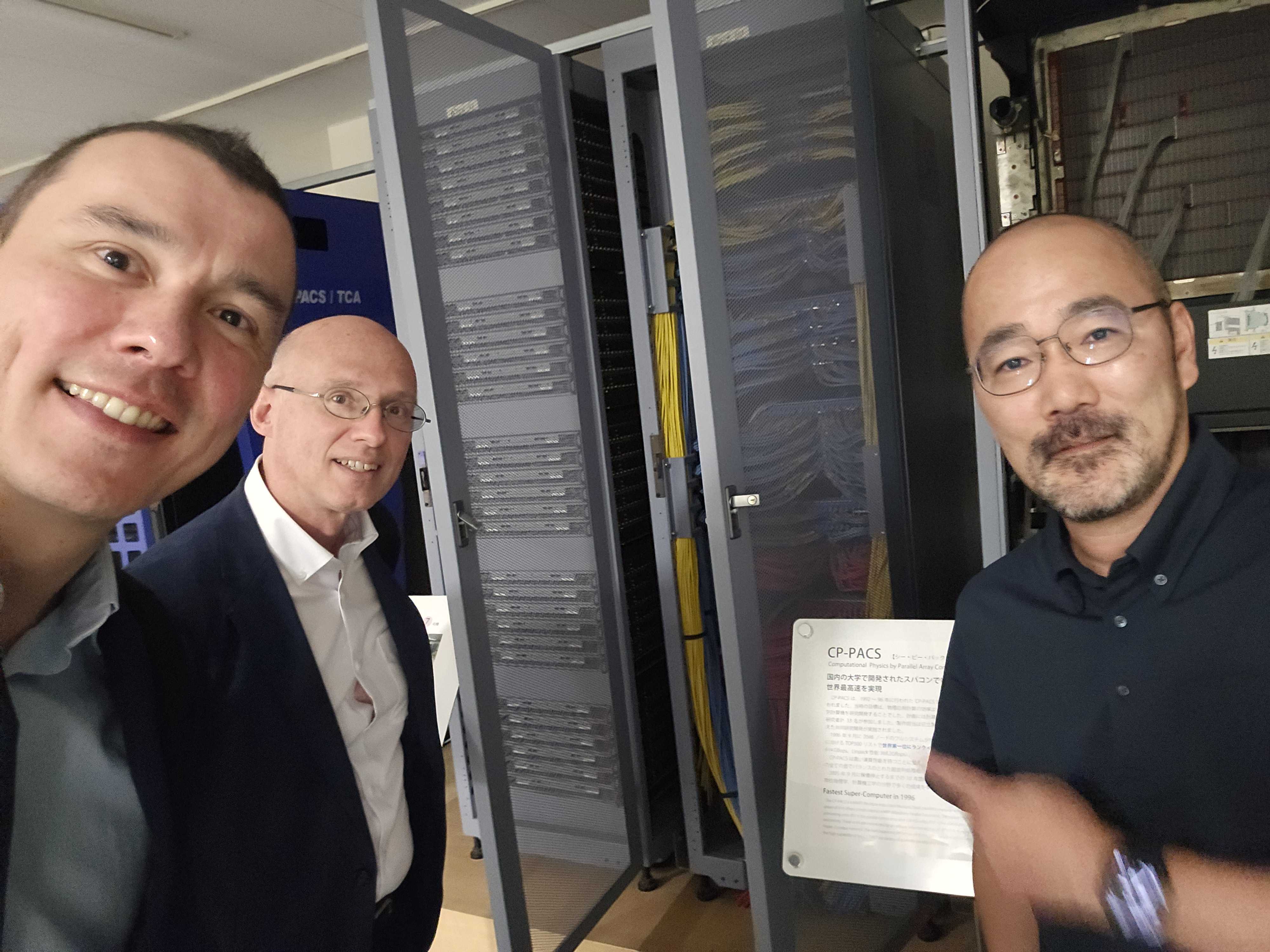 A group selfie in front of the CP-PACS supercomputer at CCS