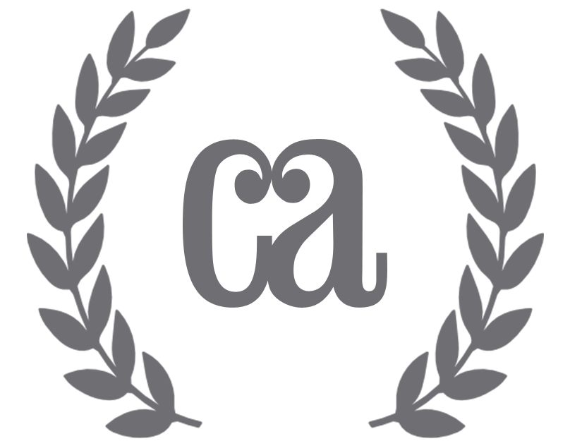 Gray emblem with stylized 'Communication Arts' logo surrounded by a laurel wreath, representing recognition or an award