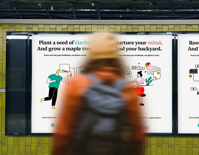 Blurred pedestrian walking past illustrated mindfulness campaign posters in a transit shelter, promoting meditation and tree planting.