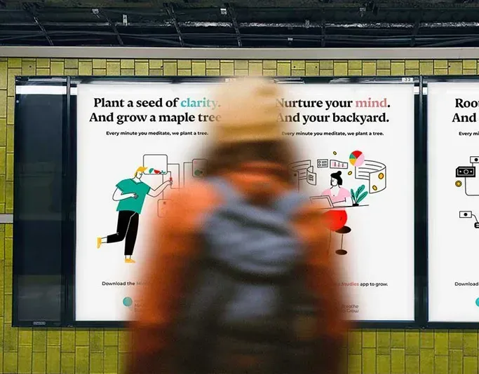 Blurred pedestrian walking past illustrated mindfulness campaign posters in a transit shelter, promoting meditation and tree planting.