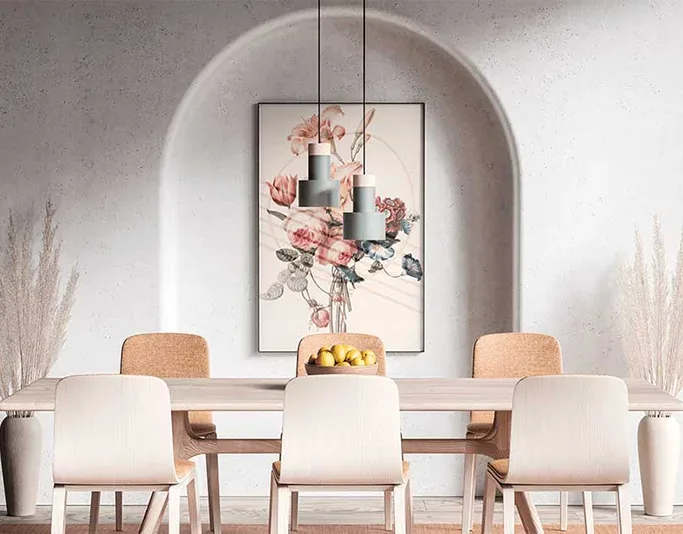 Modern dining room with a floral painting and pendant lights in a concrete arch setting.