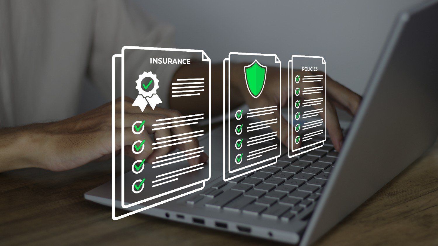Three transparent insurance and policy document icons are displayed above a laptop keyboard, with a person typing in the background.