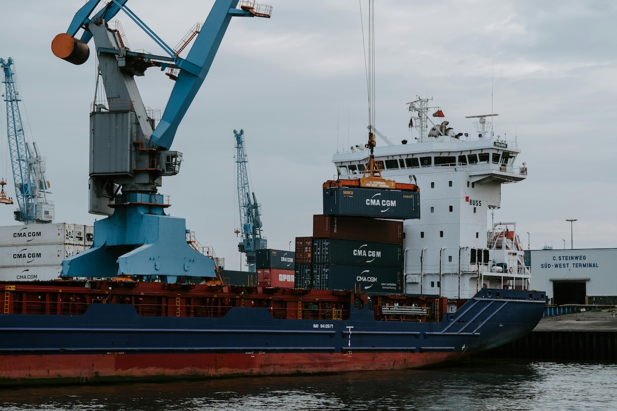 Containers being loaded onto a freight liner in port.