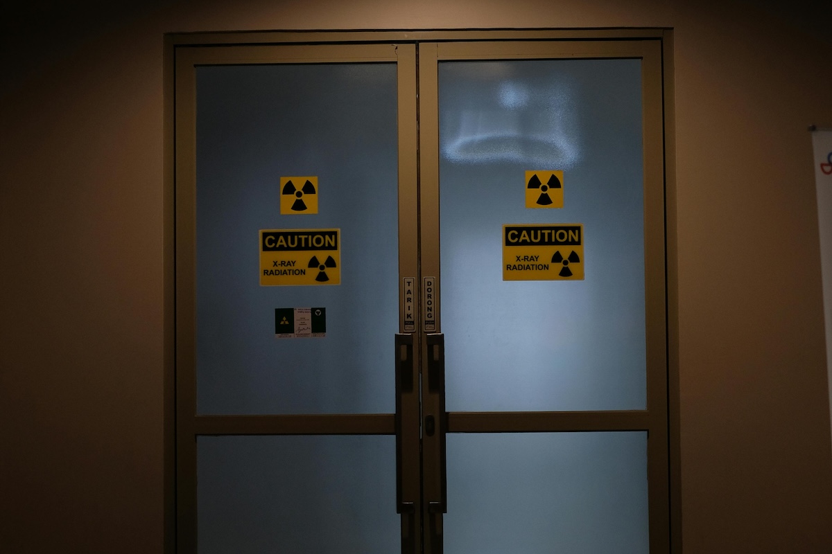 Double doors with nuclear icons on the frosted glass.