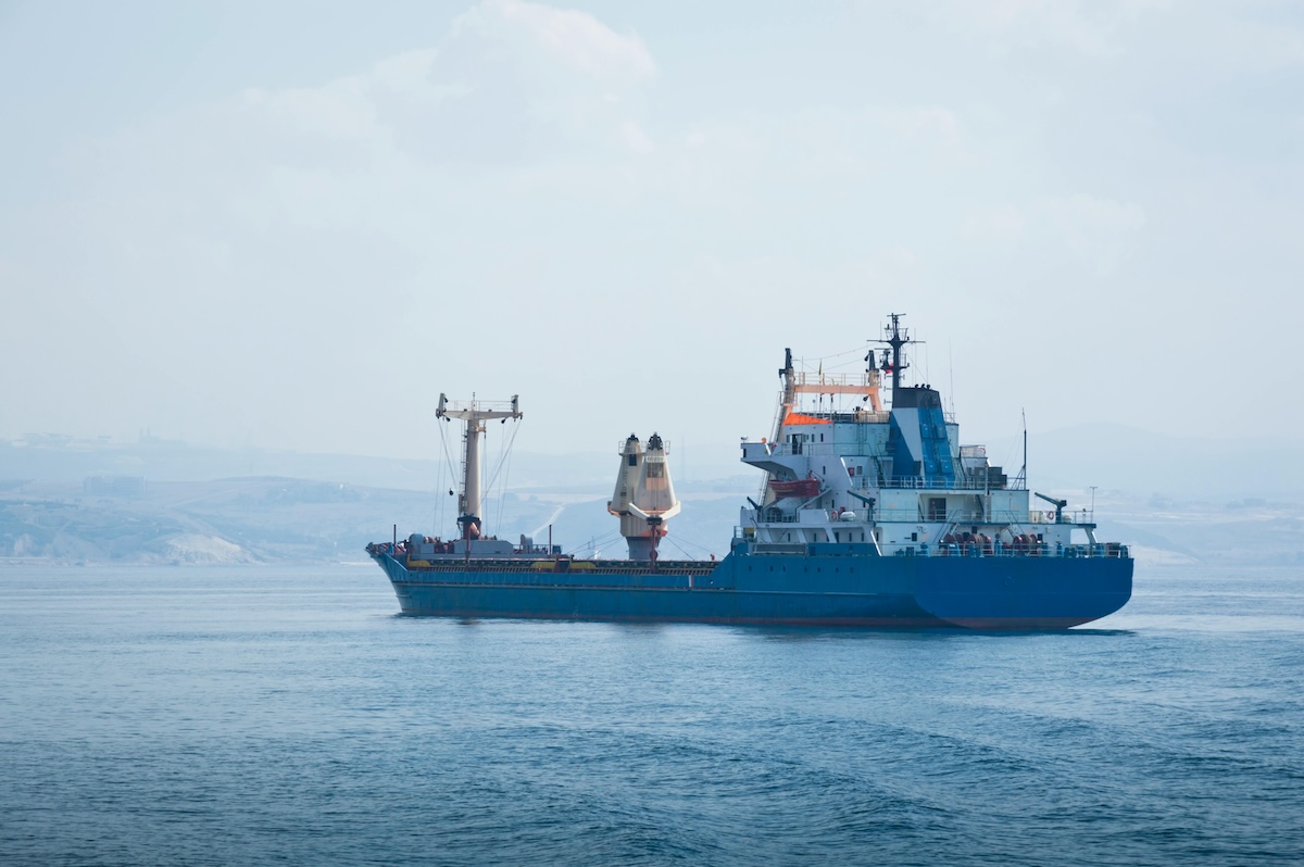 Cargo Container Ship on Calm Sea Under Clear Sky