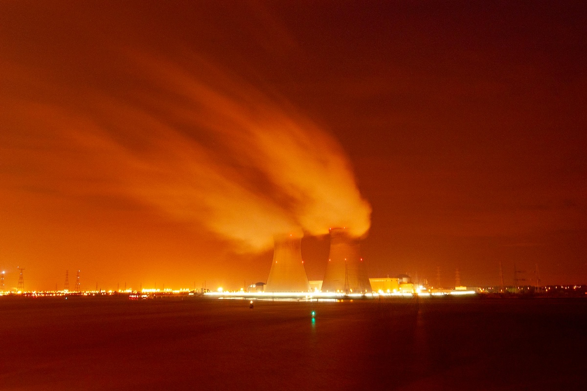 Nuclear power plant cooling towers at night.