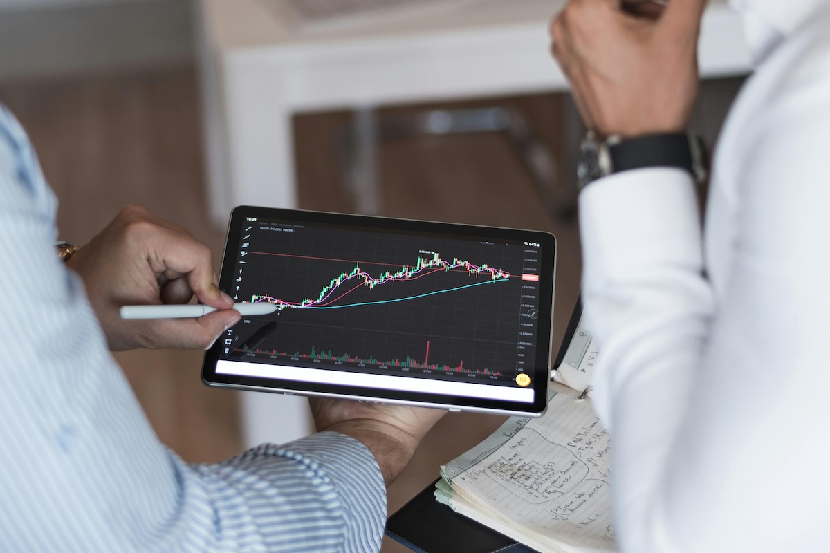 A Person in White and Blue Pin Stripe Long Sleeve Shirt Holding Black Digital Tablet
