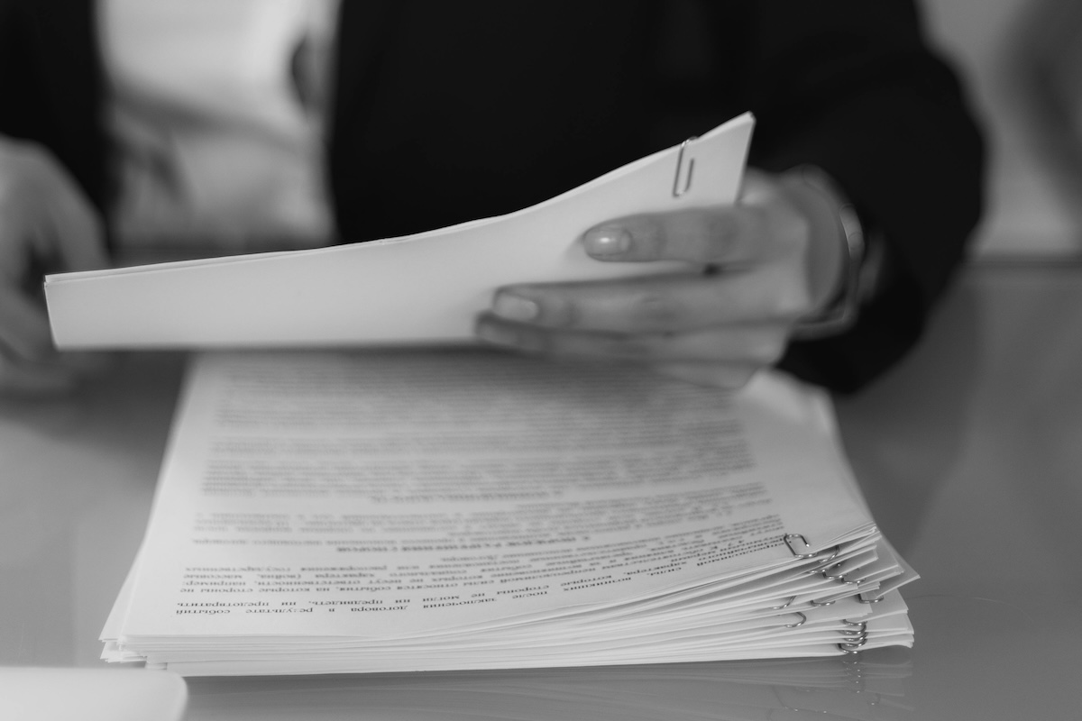 Grayscale Photo of a Woman Looking at a Document