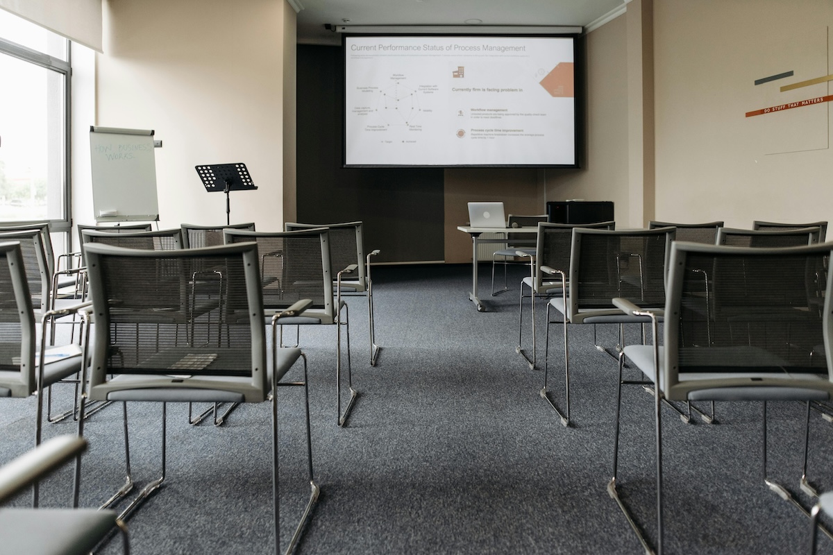 Conference room with chairs and projector on a wall.