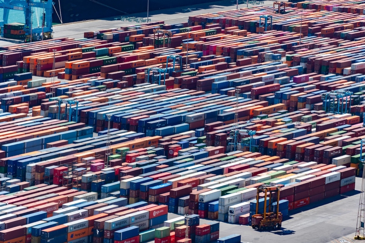 A bustling port with colorful cargo containers, aerial view showcasing global trade.