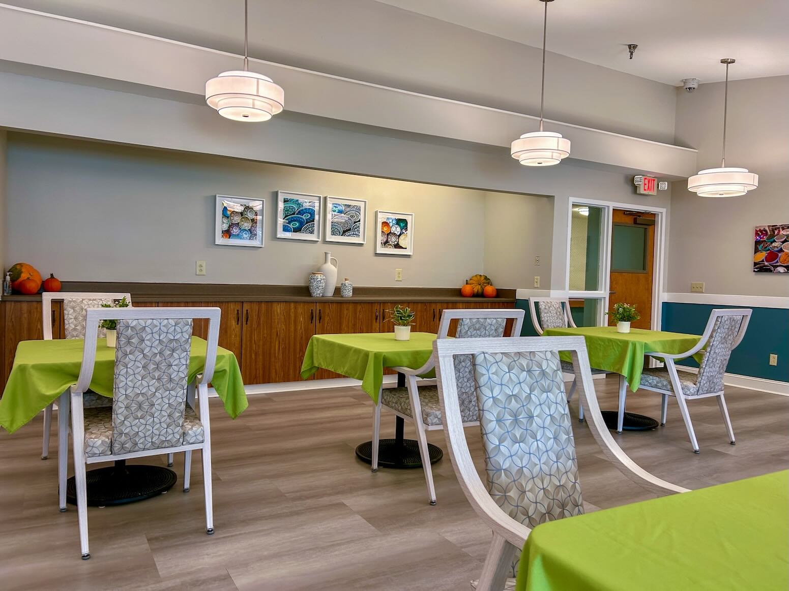 River's Bend main dining room showing chairs with green tablecloths.