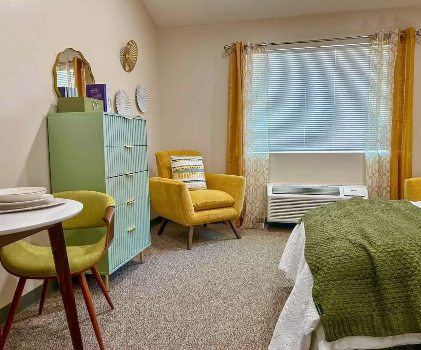 Assisted Living Studio showing chair, table and dresser at River's Bend Assisted Living.