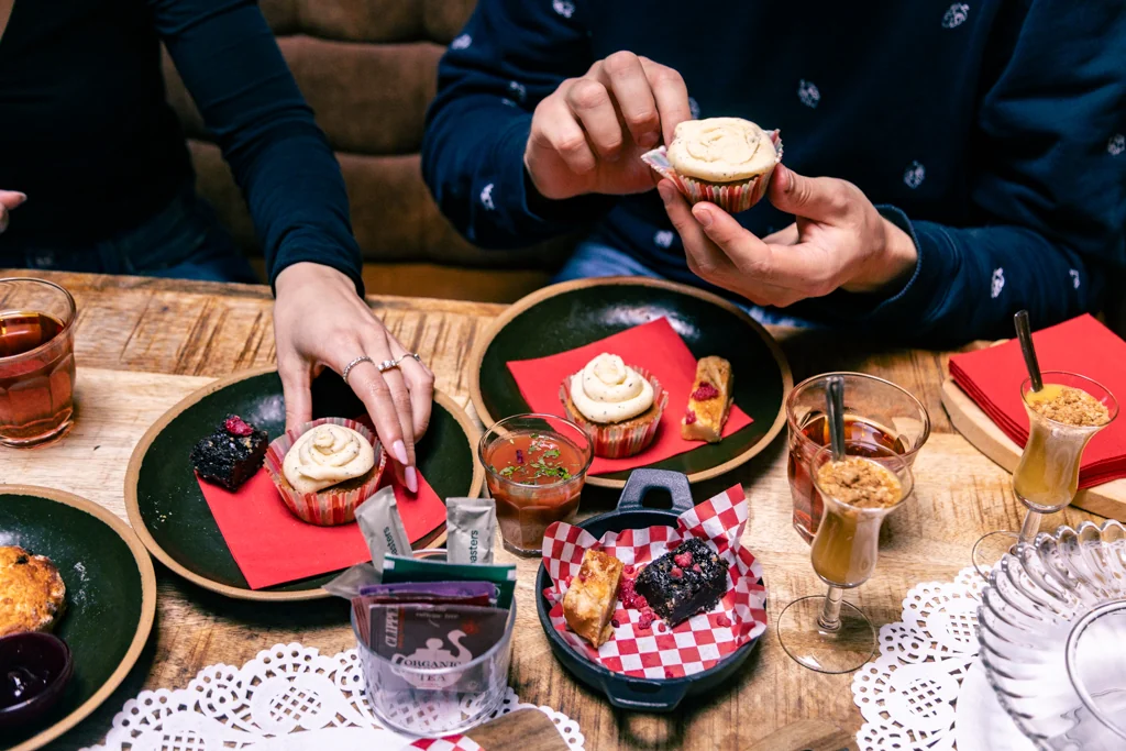 Guests sharing sweet pastries during the vegan High Tea
